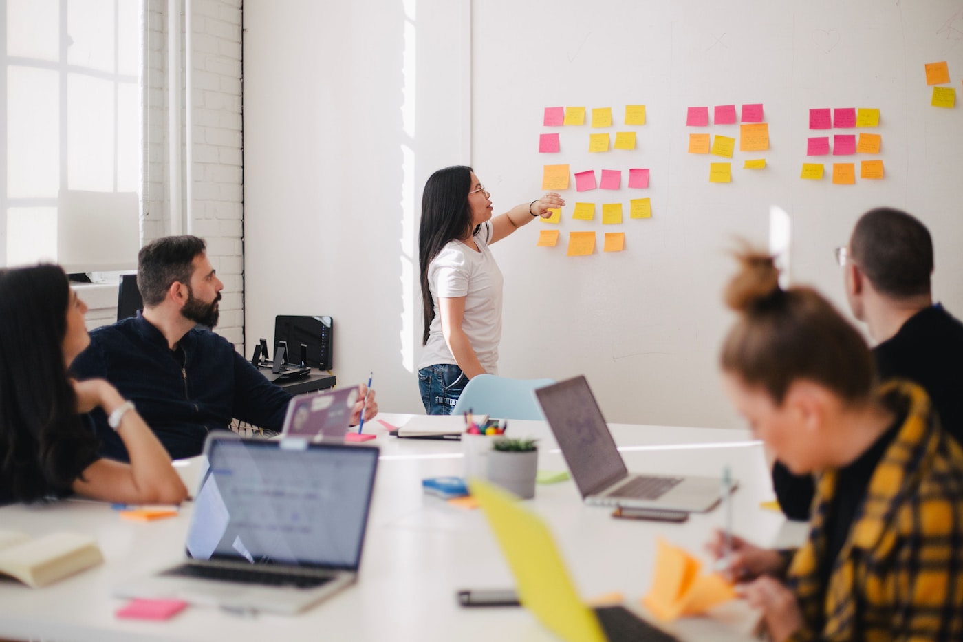 Brand review session with printed proofs spread across a studio table